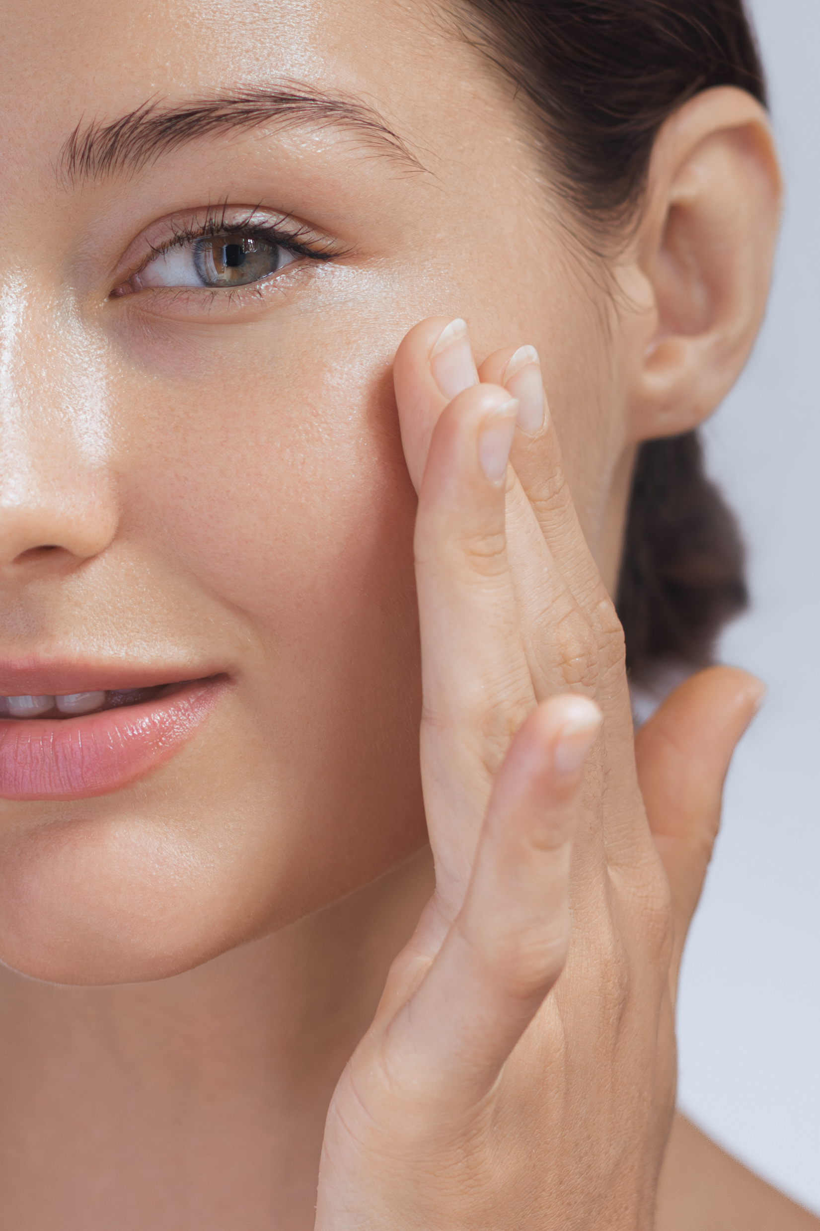 Crop Photo of Cosmetics Skin Care Concept Photo of Close-up Woman Perfect Face with Hydrated Skin High-quality crop photo of skincare and cosmetics concept for social media. Woman with beautiful face touching healthy facial skin portrait. Beautiful happy Asian girl model with natural makeup enjoys glowing hydrated skin
